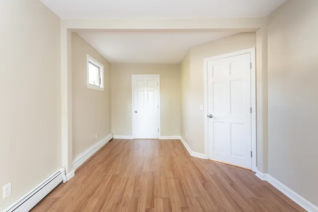a view of a room with wooden floor and closet