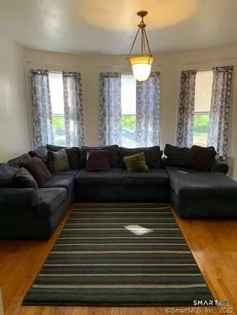 a living room with furniture and a chandelier