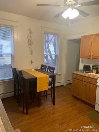 a view of a dining room with furniture window and wooden floor