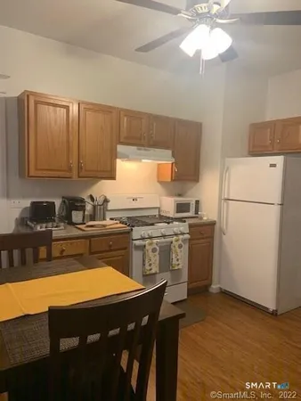 a kitchen with a table chairs stove and refrigerator