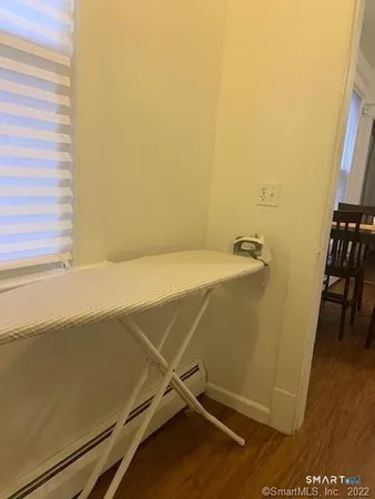 a view of a room with wooden floor