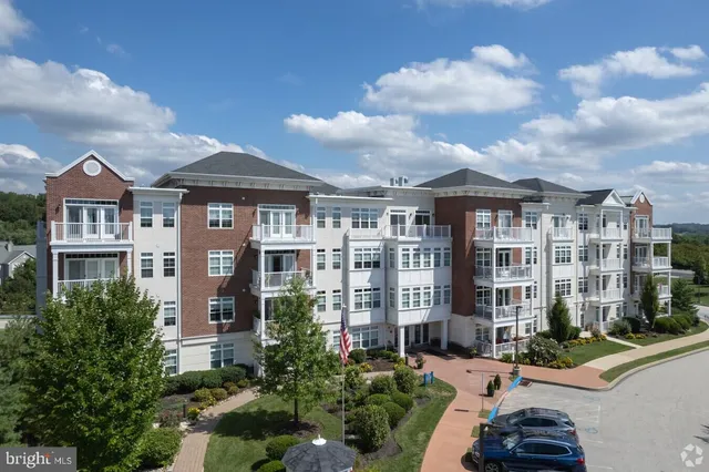 a front view of a residential apartment building with a yard