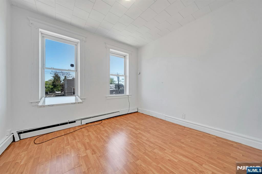 41 Heckel Street, Unit 2L Belleville, NJ 07109 - Photo 2 of 9 a view of an empty room with wooden floor and a window