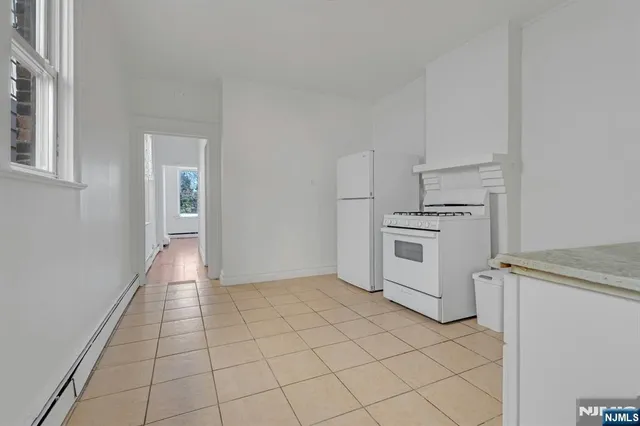 a view of a kitchen with white cabinets