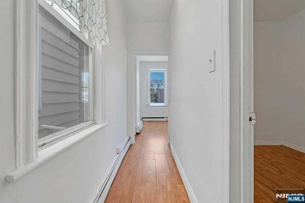 41 Heckel Street, Unit 2L Belleville, NJ 07109 - Photo 7 of 9 a view of a hallway with wooden floor and staircase