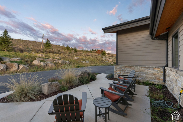 1130 Pace Road Park City, UT 84098 - Photo 60 of 73 Exterior featuring horizontal siding, stone facade, covered patio, and concrete hardscaping