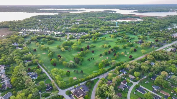 a view of a city with lush green forest