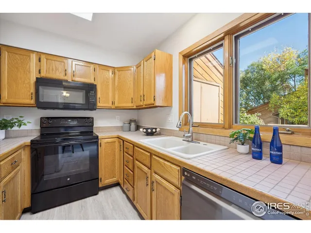 a kitchen with a sink a stove and cabinets