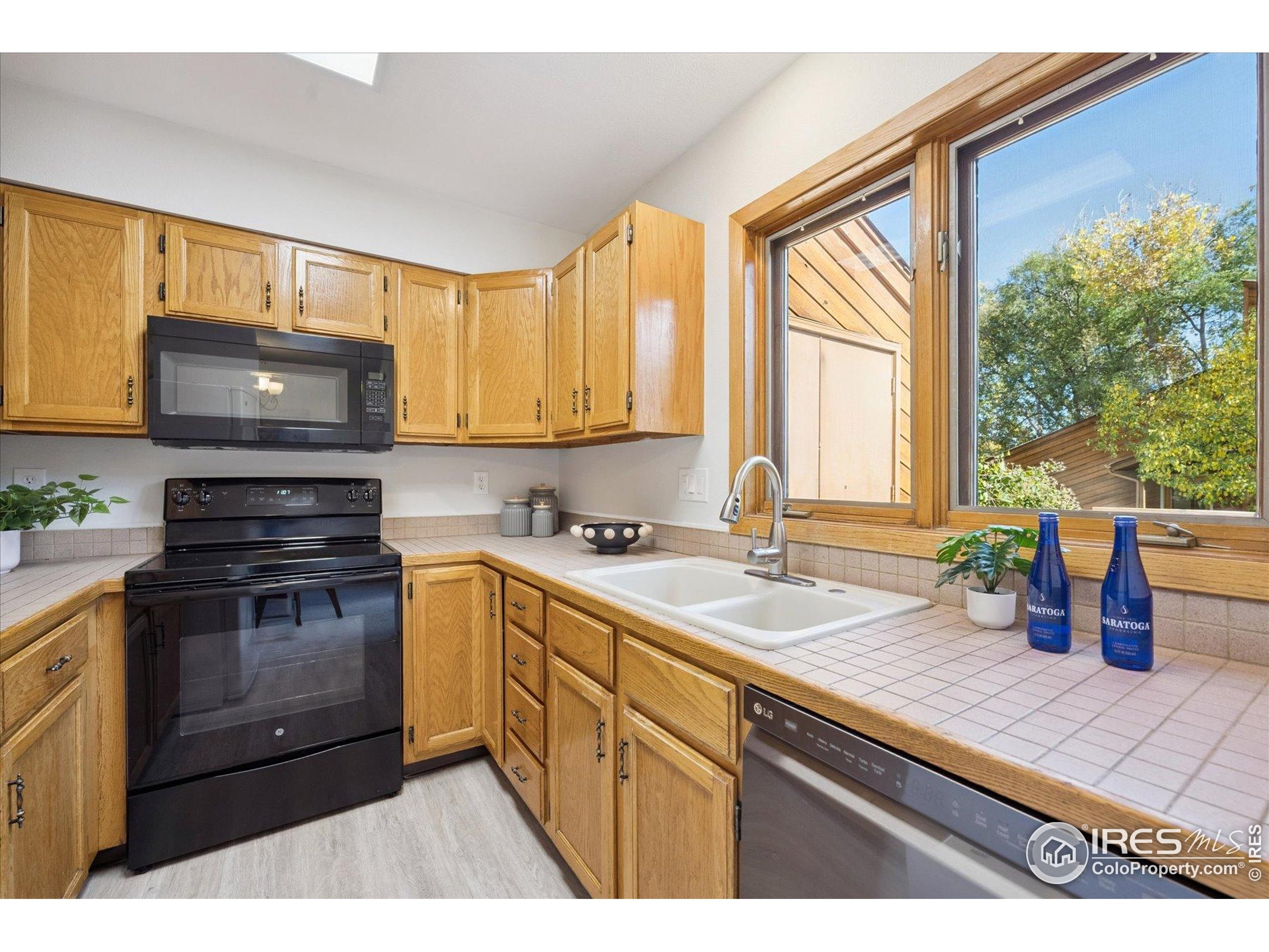 3330 34th Street Boulder, CO 80301 - Photo 12 of 32 a kitchen with a sink a stove and cabinets