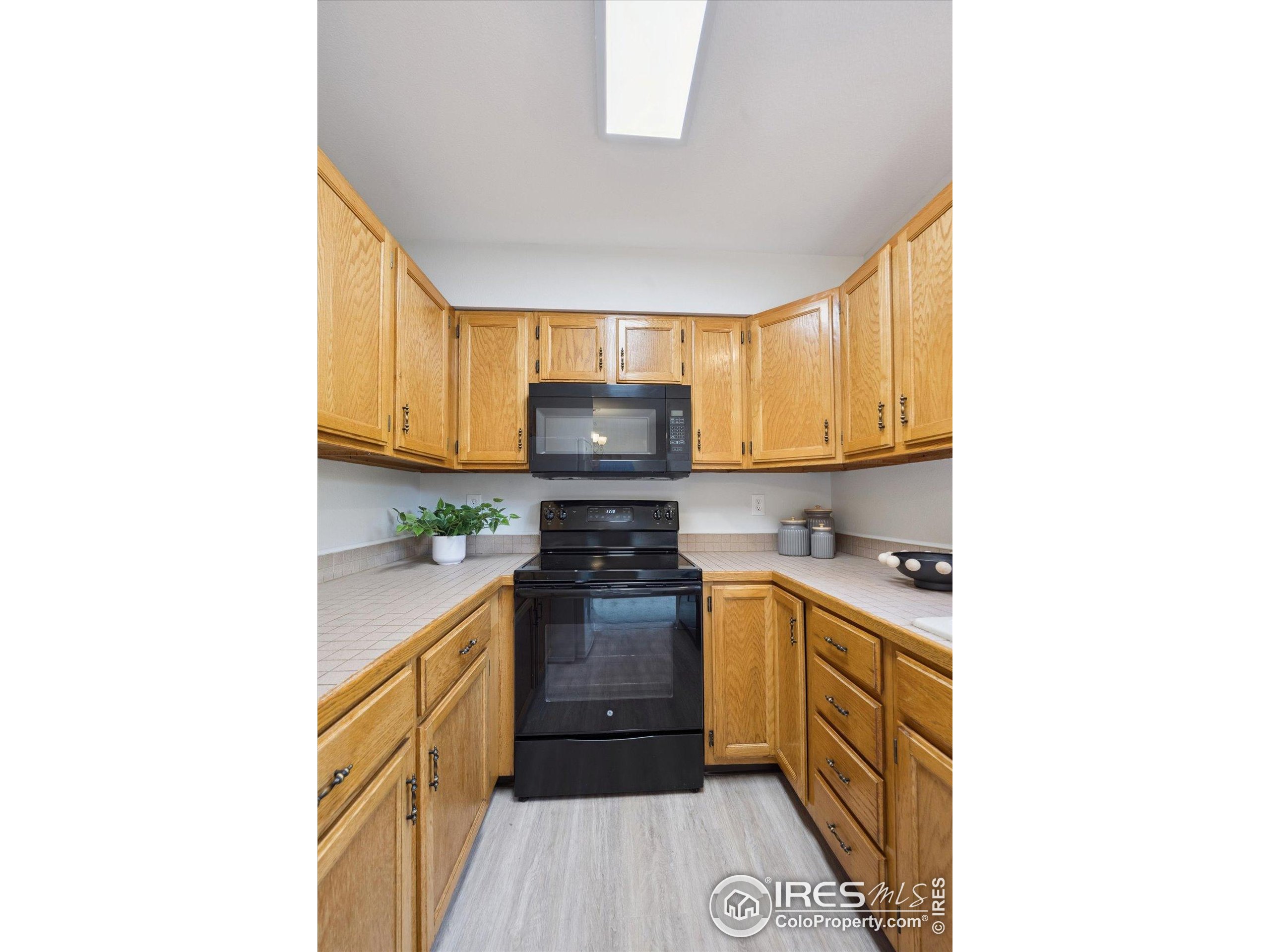 3330 34th Street Boulder, CO 80301 - Photo 13 of 32 a kitchen with a sink a stove and cabinets