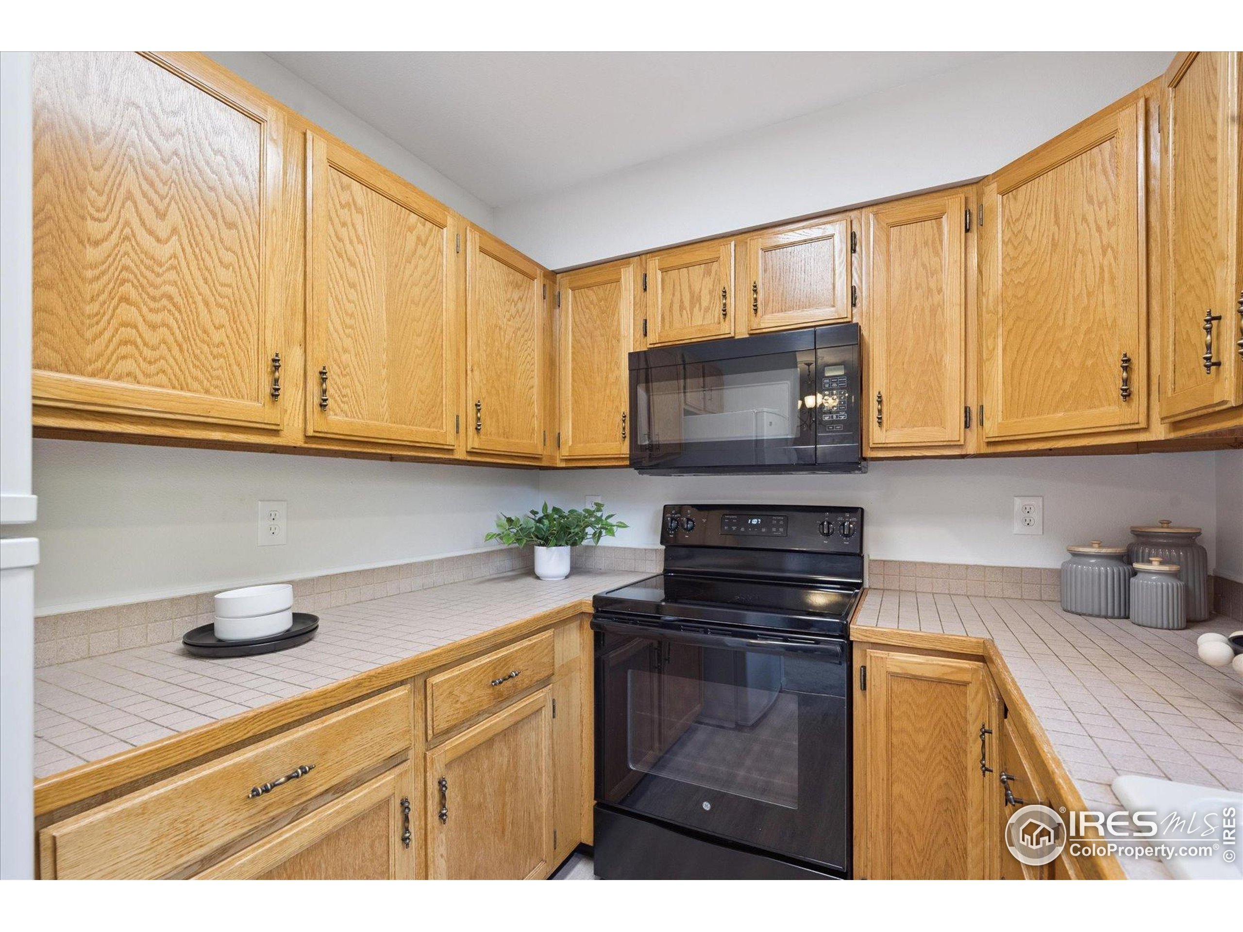 3330 34th Street Boulder, CO 80301 - Photo 14 of 32 a kitchen with stainless steel appliances granite countertop a sink a stove cabinets and a counter top space