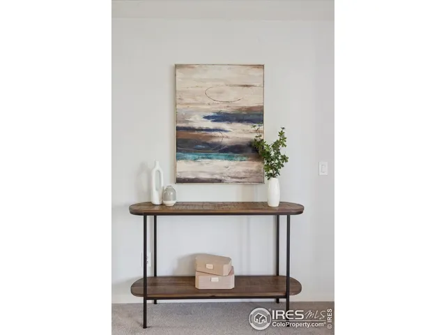 a living room with furniture and a painting