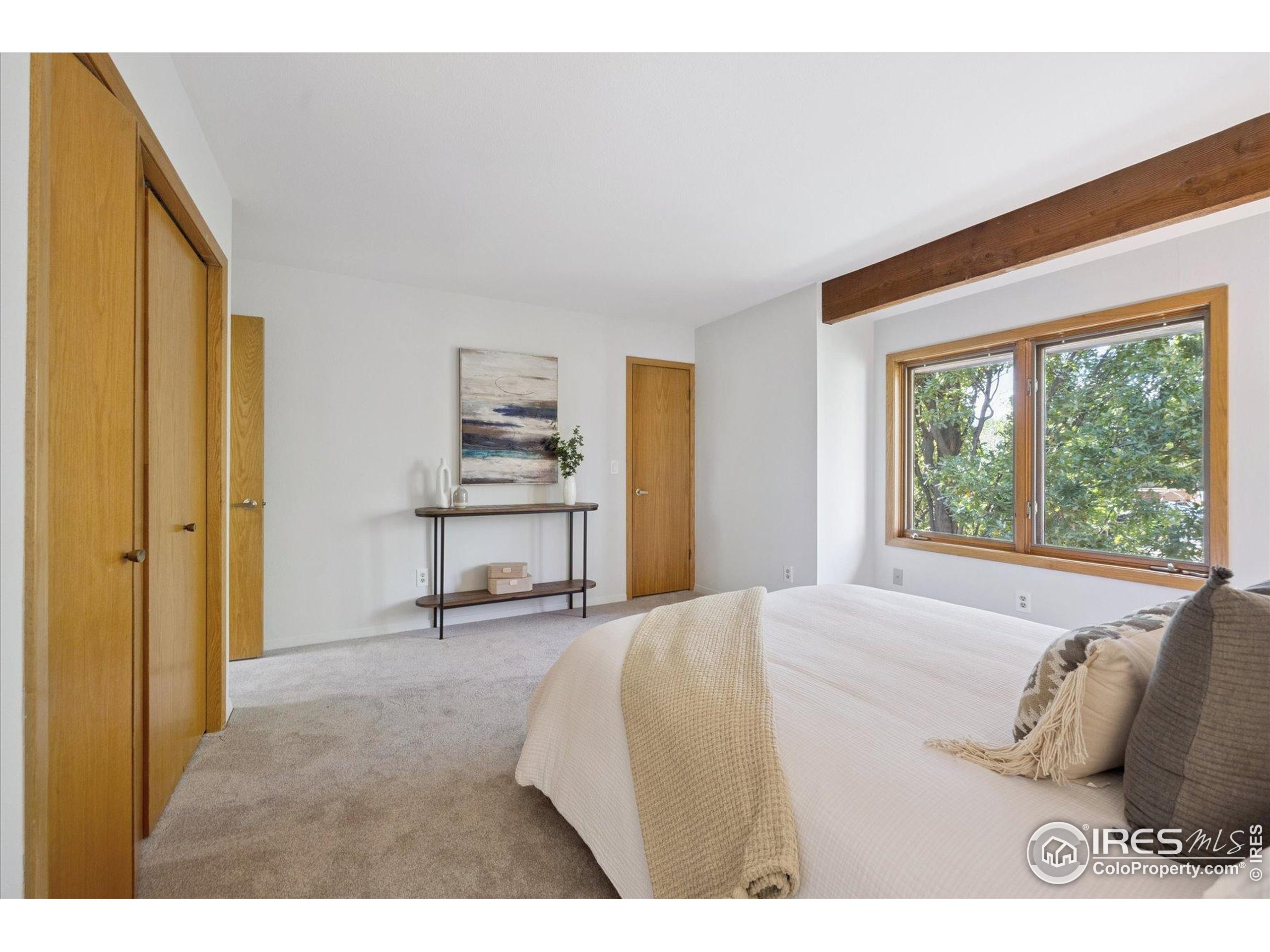 3330 34th Street Boulder, CO 80301 - Photo 19 of 32 a spacious bedroom with a bed and a large window