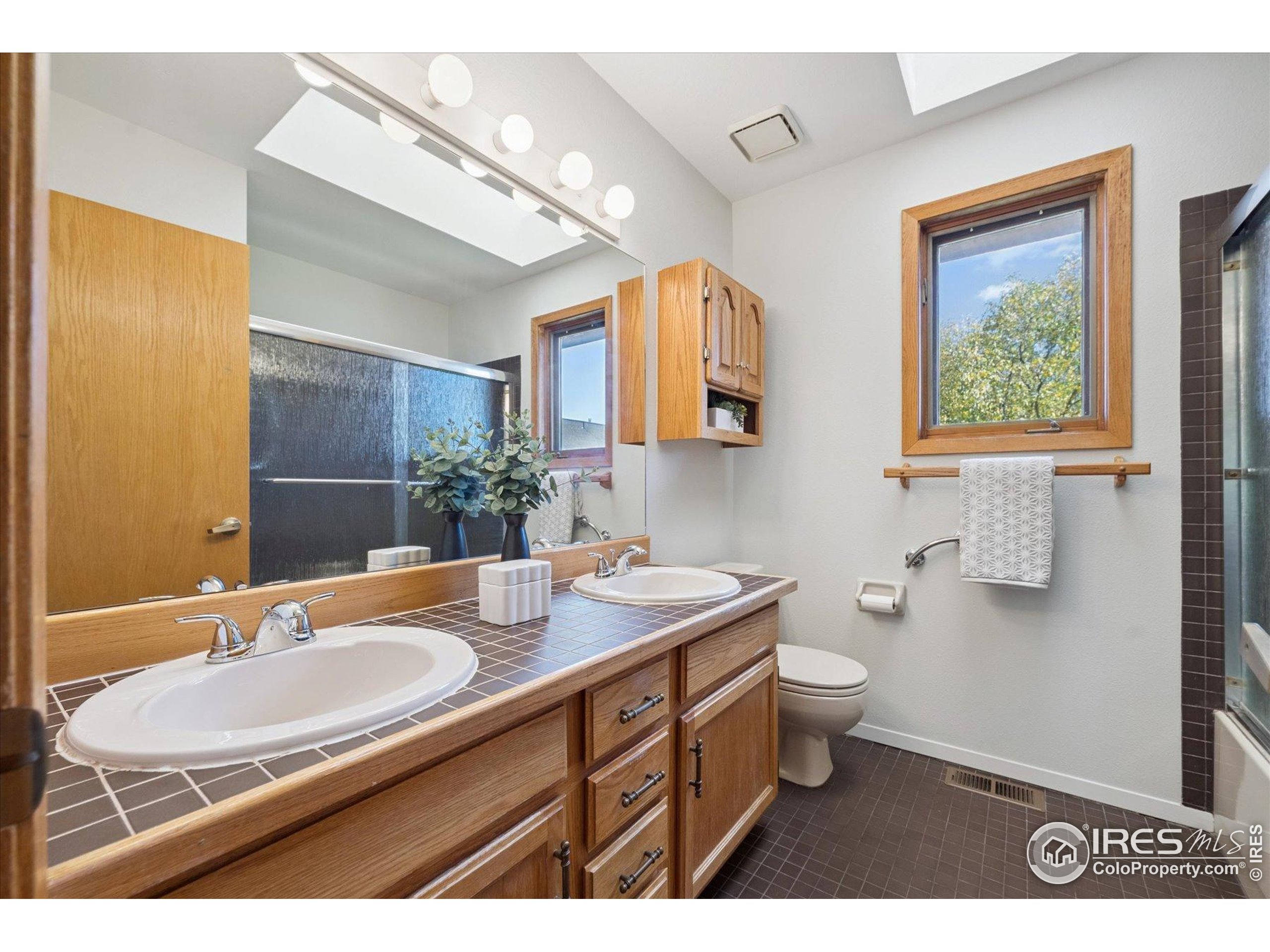 3330 34th Street Boulder, CO 80301 - Photo 20 of 32 a bathroom with a sink double vanity granite and a toilet