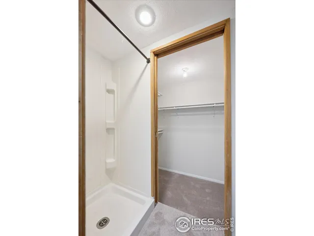 a bathroom with a glass shower door
