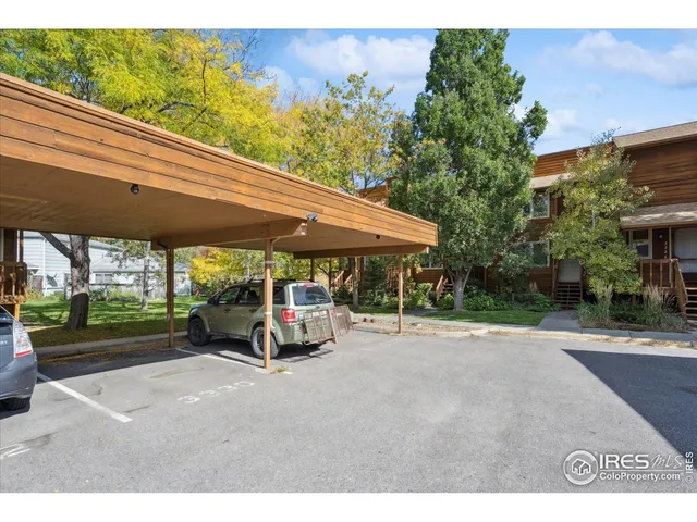 a view of a patio with table and chairs under an umbrella
