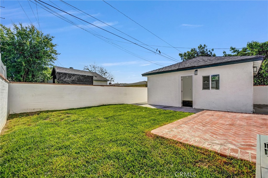 1200 South Castlegate Avenue Compton, CA 90221 - Photo 35 of 39 Backyard left view with garage