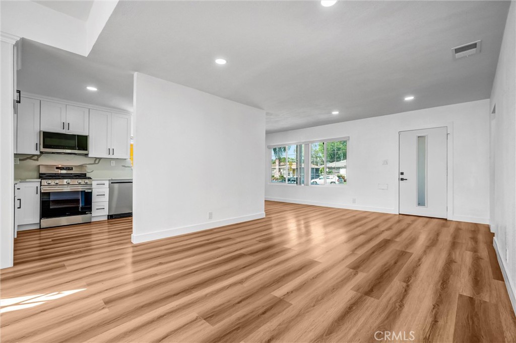 1200 South Castlegate Avenue Compton, CA 90221 - Photo 9 of 39 living room, facing front door and kitchen