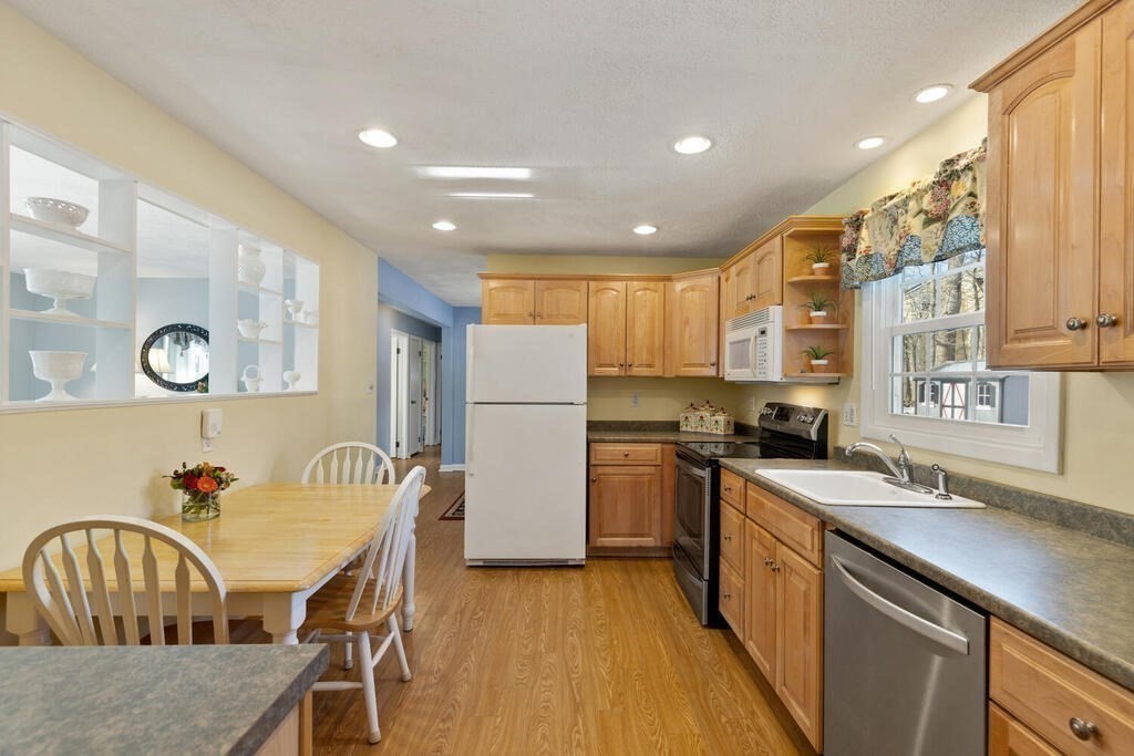 23 Walker Road Beverly, MA 01915 - Photo 15 of 33 a kitchen with stainless steel appliances granite countertop a kitchen island hardwood floor sink stove and granite counter top
