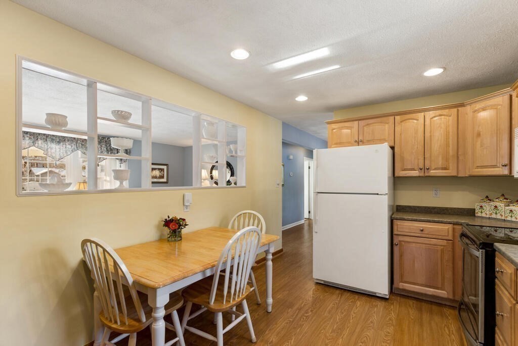 23 Walker Road Beverly, MA 01915 - Photo 16 of 33 a kitchen with a refrigerator a stove a sink dishwasher with a dining table and chairs