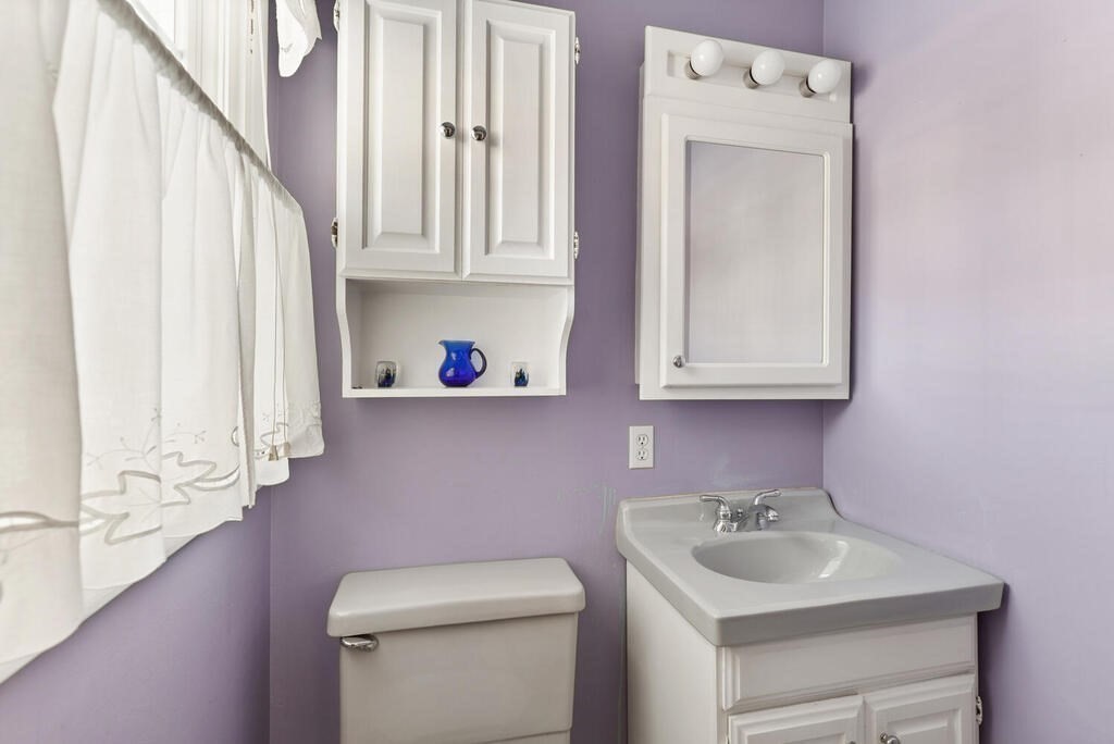 23 Walker Road Beverly, MA 01915 - Photo 23 of 33 a bathroom with a sink a toilet and a mirror