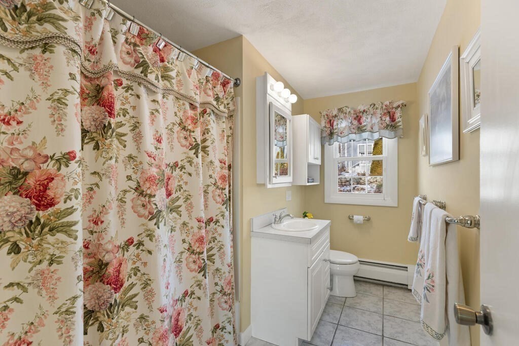 23 Walker Road Beverly, MA 01915 - Photo 24 of 33 a white toilet sitting next to a bathroom sink