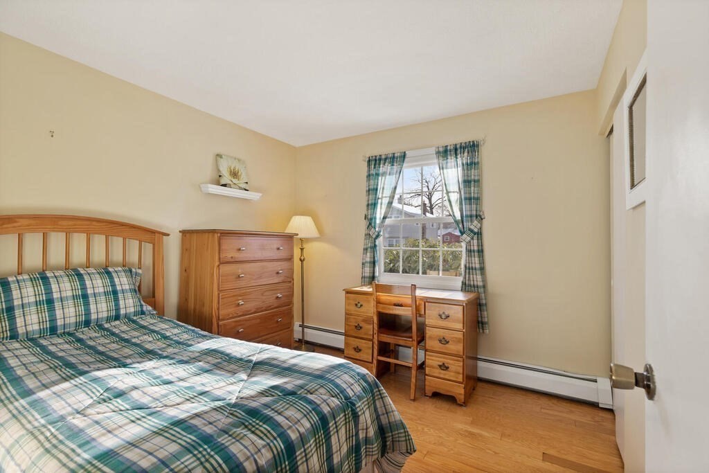 23 Walker Road Beverly, MA 01915 - Photo 25 of 33 a bedroom with a bed and wooden floor