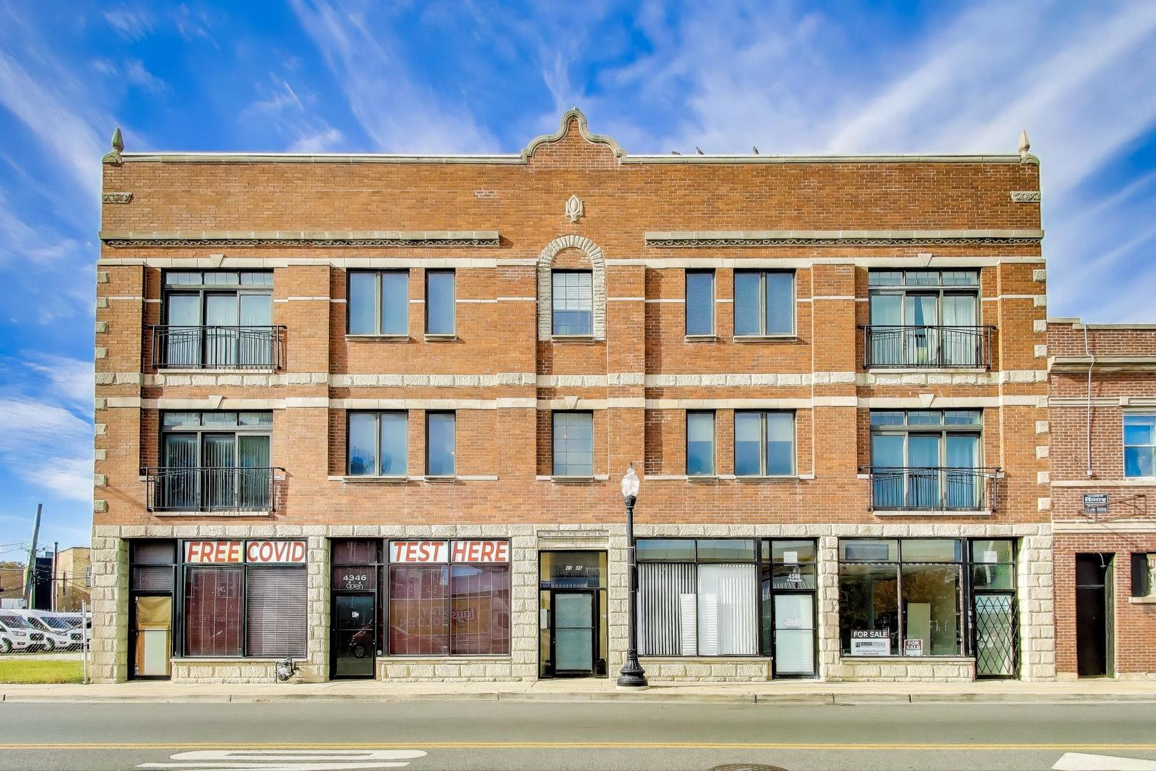 a front view of a residential apartment building with a yard