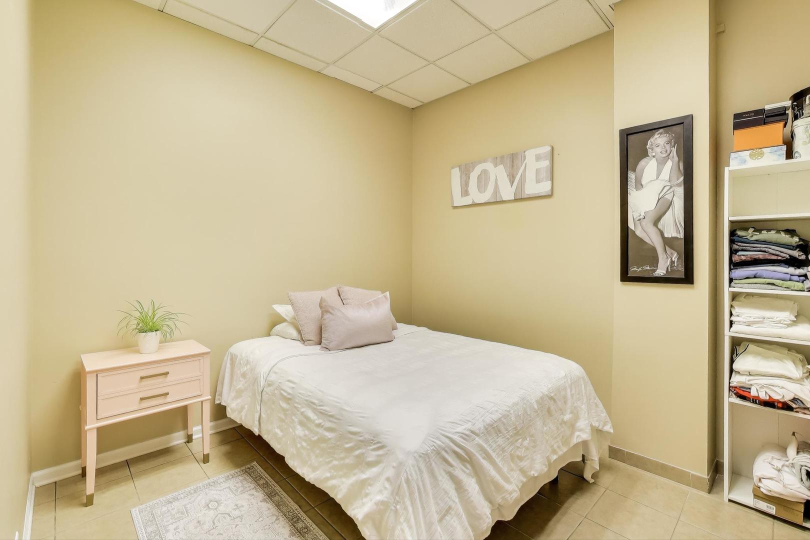 4346 North Pulaski Road, Unit C Chicago, IL 60641 - Photo 12 of 20 a bedroom with a bed and painting on the wall