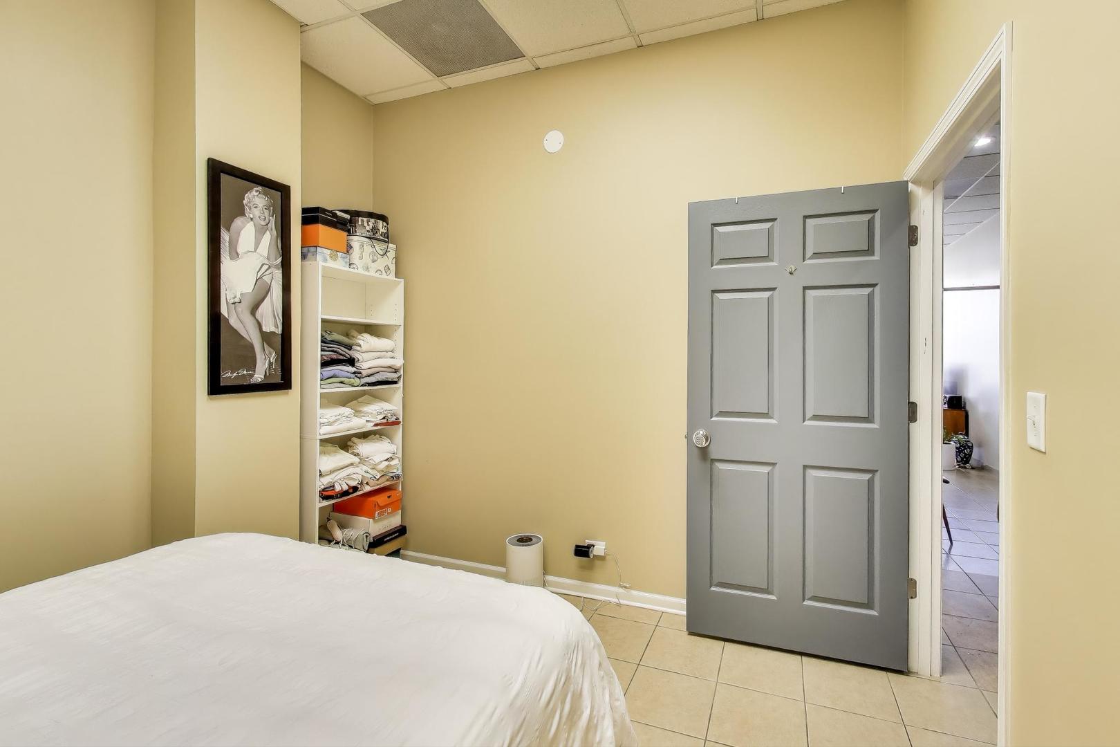 4346 North Pulaski Road, Unit C Chicago, IL 60641 - Photo 13 of 20 a bedroom with a bed and a cabinets