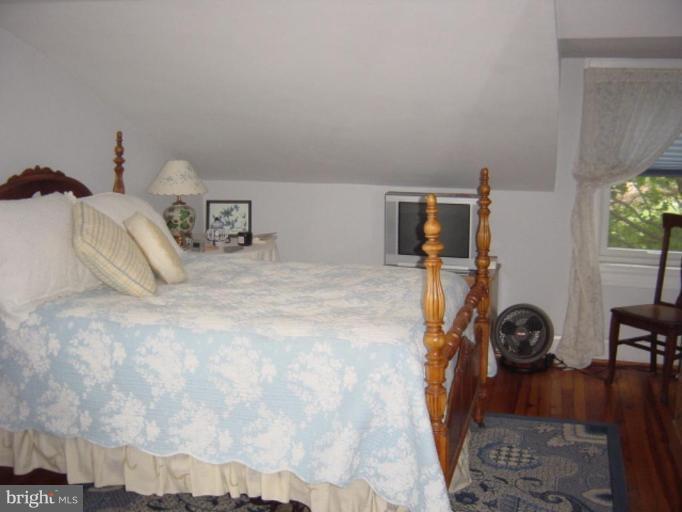 6508 Banbury Road Baltimore, MD 21239 - Photo 11 of 26 a bedroom with a bed and a cabinets
