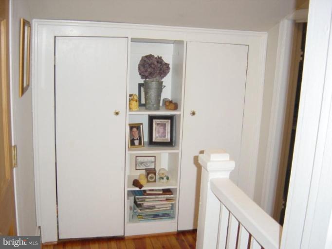 6508 Banbury Road Baltimore, MD 21239 - Photo 14 of 26 a view of a hallway with wooden floor and closet
