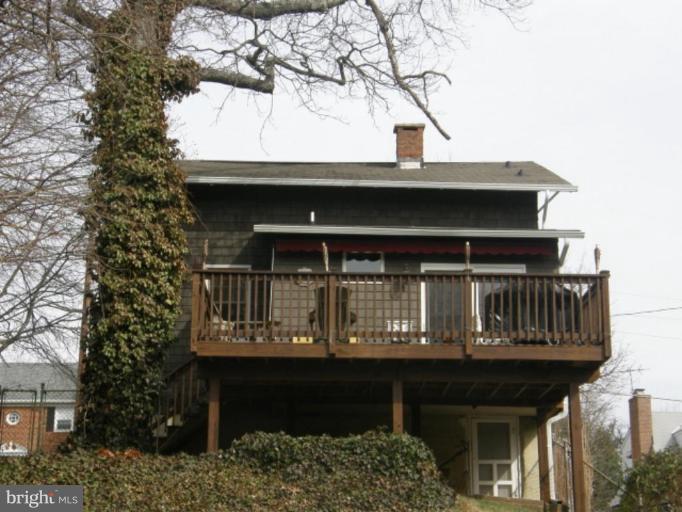 6508 Banbury Road Baltimore, MD 21239 - Photo 15 of 26 a front view of house with deck and outdoor seating
