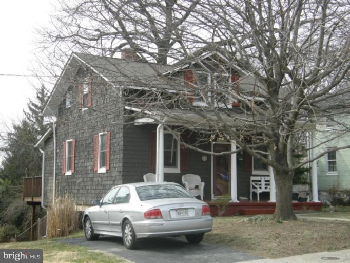 6508 Banbury Road Baltimore, MD 21239 - Photo 16 of 26 a car parked in front of a brick house
