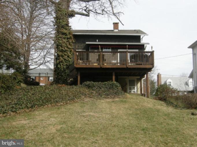 6508 Banbury Road Baltimore, MD 21239 - Photo 18 of 26 a view of a house with large trees