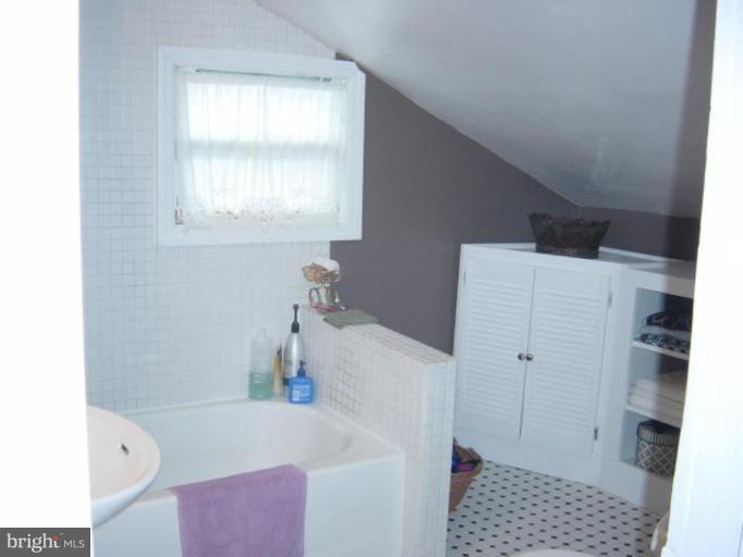 6508 Banbury Road Baltimore, MD 21239 - Photo 24 of 26 a bathroom with a bathtub sink and toilet