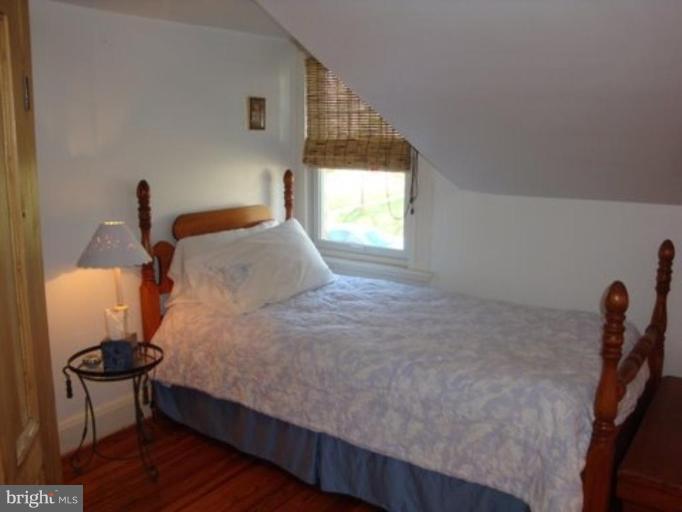 6508 Banbury Road Baltimore, MD 21239 - Photo 25 of 26 a bedroom with a bed and a window