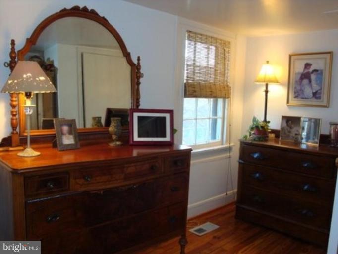 6508 Banbury Road Baltimore, MD 21239 - Photo 26 of 26 a kitchen with a sink and a stove with wooden floor