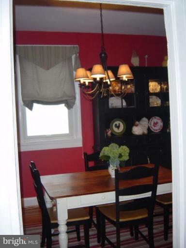 6508 Banbury Road Baltimore, MD 21239 - Photo 4 of 26 a view of a dining room with furniture and chandelier