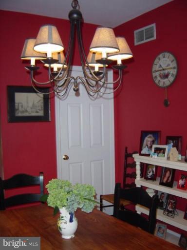6508 Banbury Road Baltimore, MD 21239 - Photo 5 of 26 a table with a vase and flowers on it