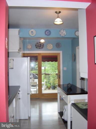 6508 Banbury Road Baltimore, MD 21239 - Photo 10 of 26 a kitchen with a stove a refrigerator and a fireplace