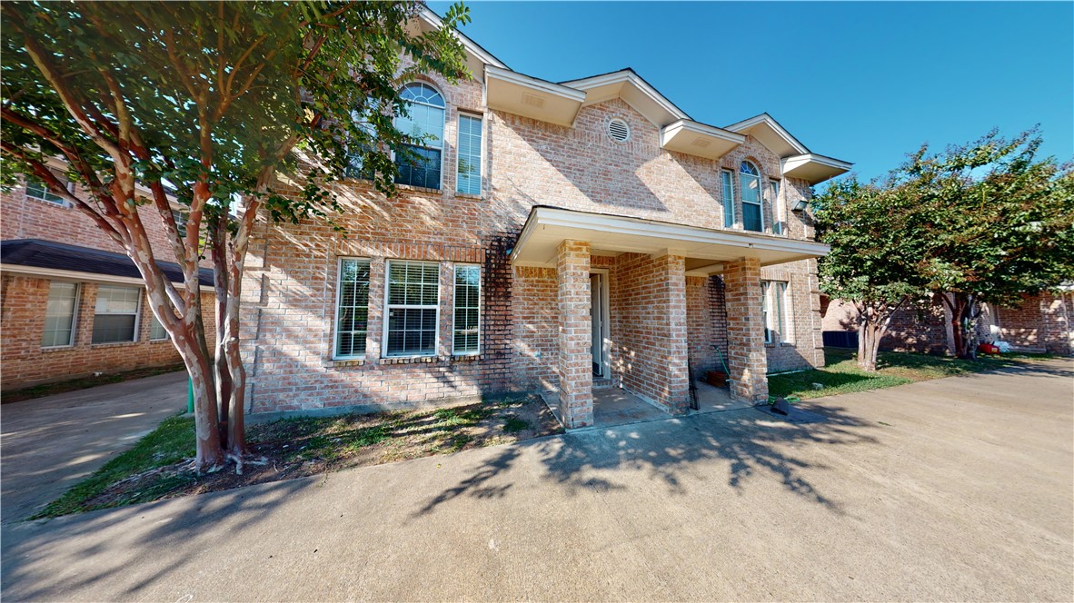 a front view of a house with a yard and outdoor seating