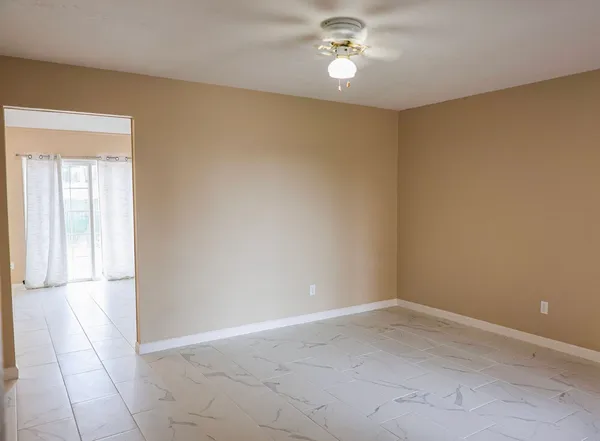 an empty room with a empty space and a ceiling fan