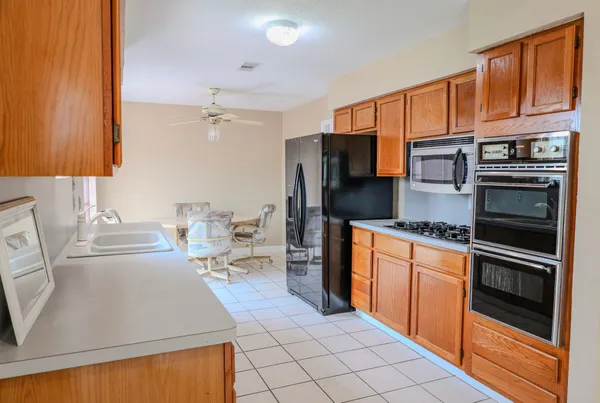 a kitchen with stainless steel appliances a stove refrigerator sink and cabinets