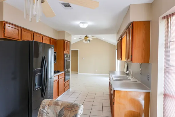 a kitchen with stainless steel appliances granite countertop a refrigerator and a sink