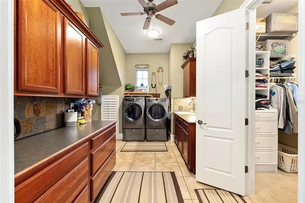 a dining hall with stainless steel appliances granite countertop a sink and a large window