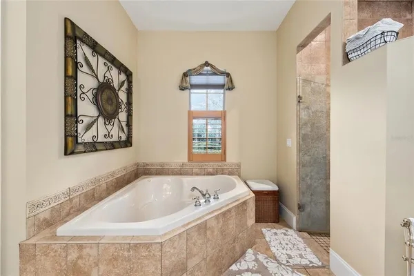 a living room with large rug stairs and a dining table