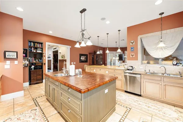 a spacious bedroom with a bed and a chandelier