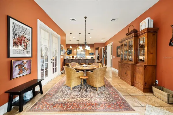 a view of a hallway with a livingroom and a chandelier