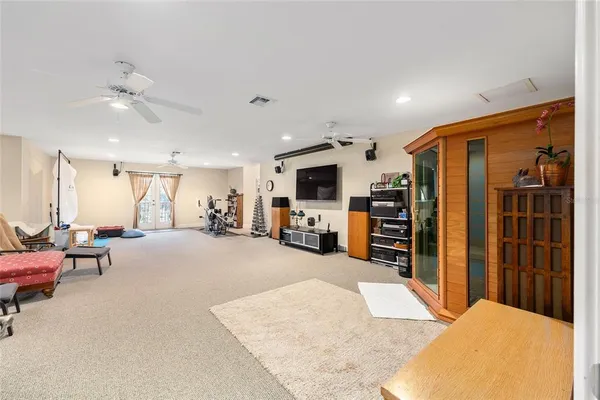 a view of a hallway with wooden floor and windows